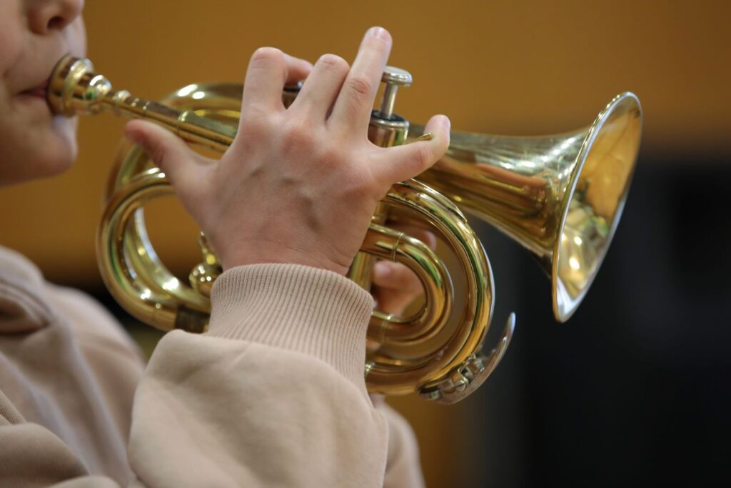 A boy playing a wind instrument.